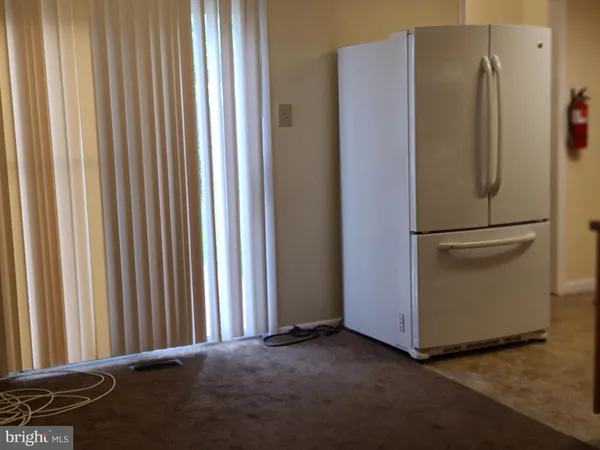 a view of a refrigerator in a kitchen