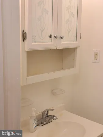 a bathroom with a sink and cabinets