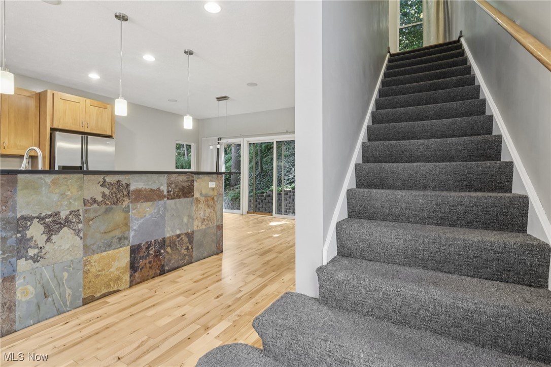 1951 Columbus Road Cleveland, OH 44113 - Photo 18 of 46 Staircase with recessed lighting and wood-style floors