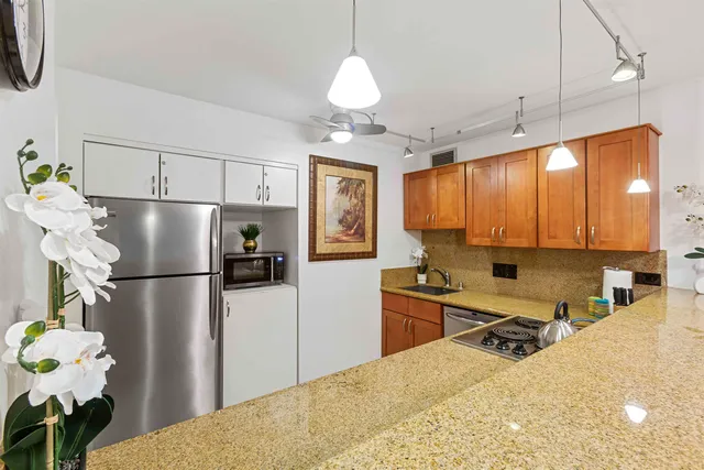 a view of washer and dryer with bathroom in the background