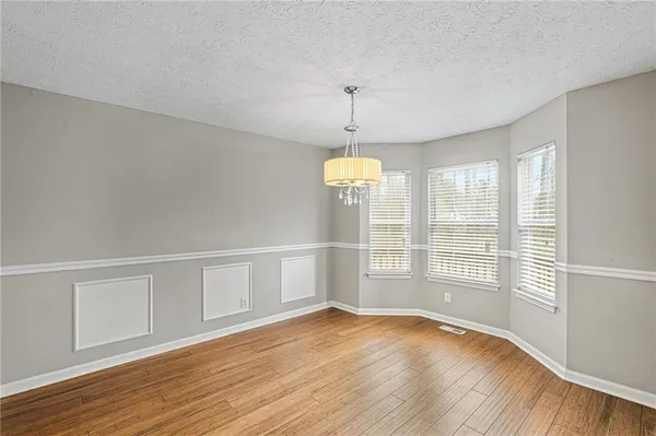 a large kitchen with stainless steel appliances granite countertop a sink stove and cabinets