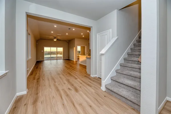 a view of entryway and hall with wooden floor