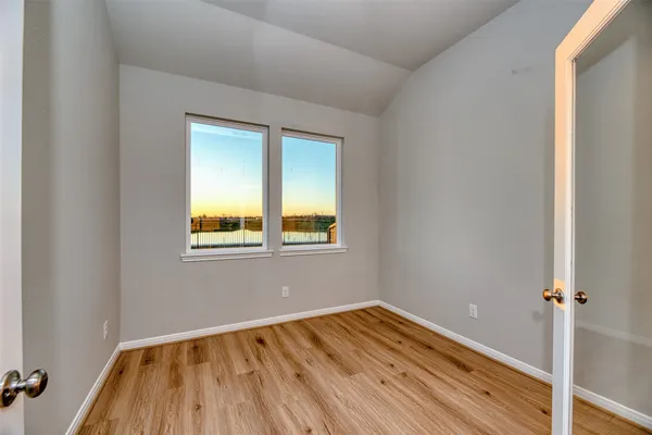 a view of a room with wooden floor and window