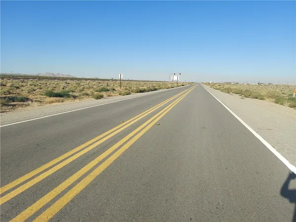 an aerial view of house with yard and mountain view in back
