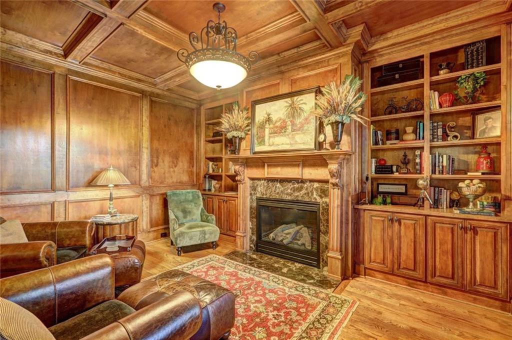 3027 Watsons Bend Milton, GA 30004 - Photo 11 of 39 a living room with furniture a flat screen tv and a fireplace