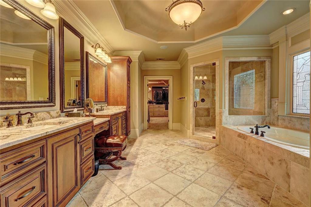 3027 Watsons Bend Milton, GA 30004 - Photo 17 of 39 a bathroom with a tub sink and mirror