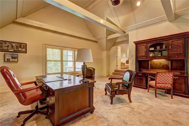 a view of a livingroom with workspace and a window