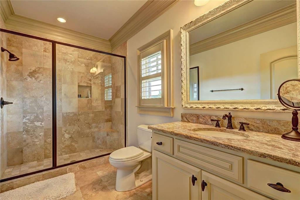 3027 Watsons Bend Milton, GA 30004 - Photo 21 of 39 a bathroom with a double vanity sink toilet and shower