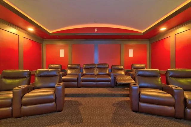 a living room with furniture a ceiling fan and a rug