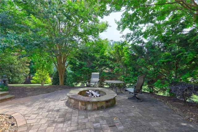 a view of a backyard with table and chairs and potted plants
