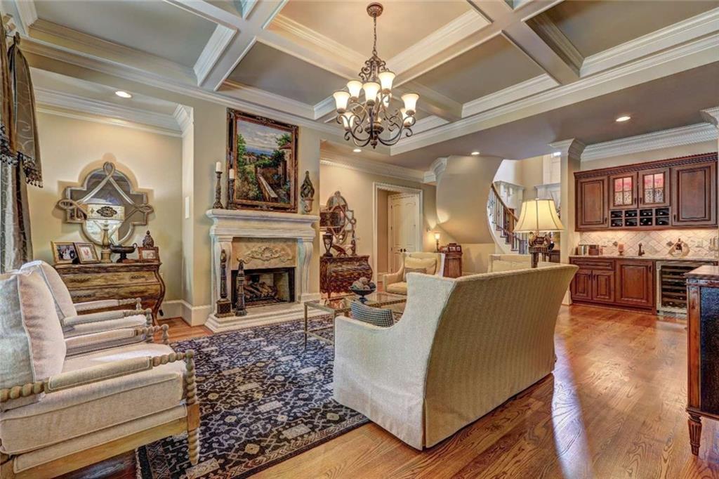3027 Watsons Bend Milton, GA 30004 - Photo 5 of 39 a living room with furniture a fireplace and chandelier