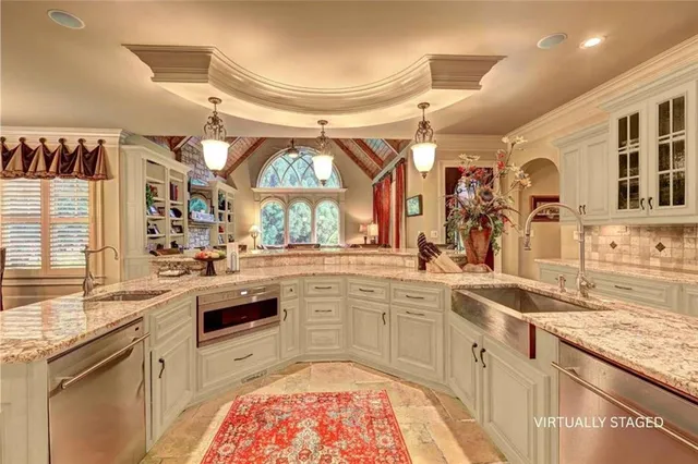 a large kitchen with a sink window and cabinets