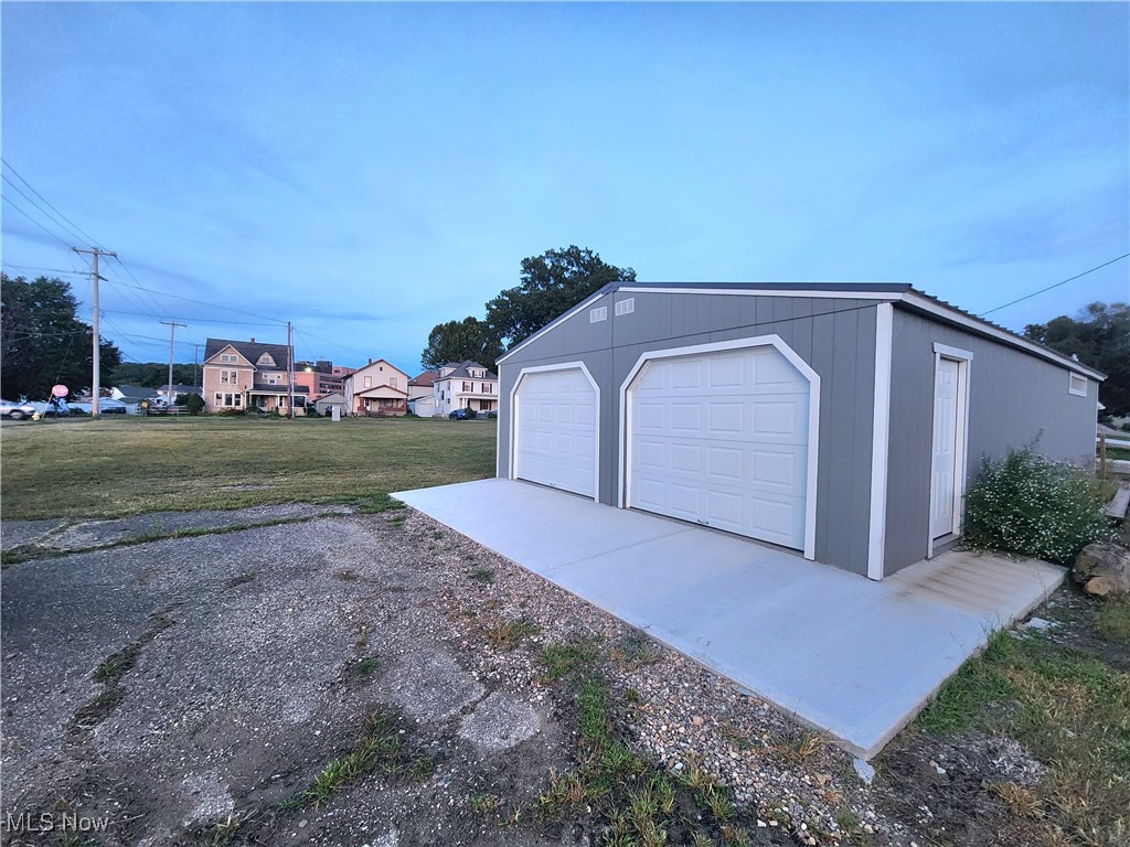 509 Cambridge Road Coshocton, OH 43812 - Photo 2 of 6 Garage with garage and a lawn