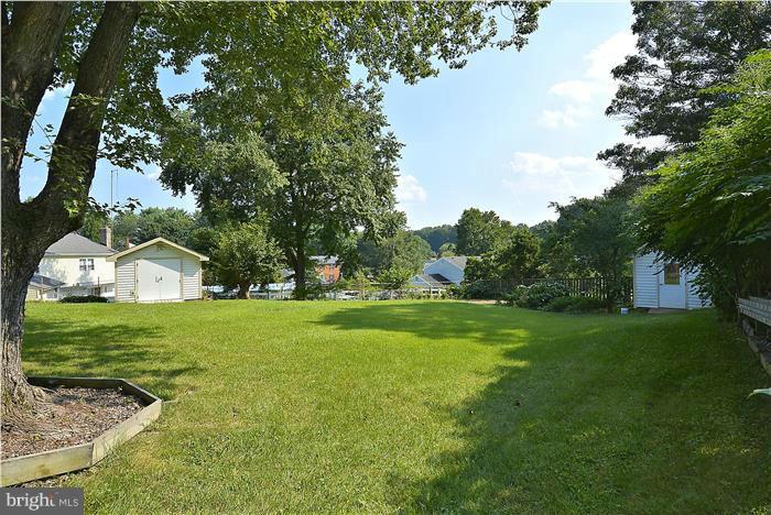 6716 Garrett Road Derwood, MD 20855 - Photo 25 of 30 a view of a trees and barn in the middle of a field