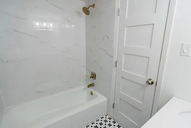 a bathroom with a bathtub a toilet and a shower
