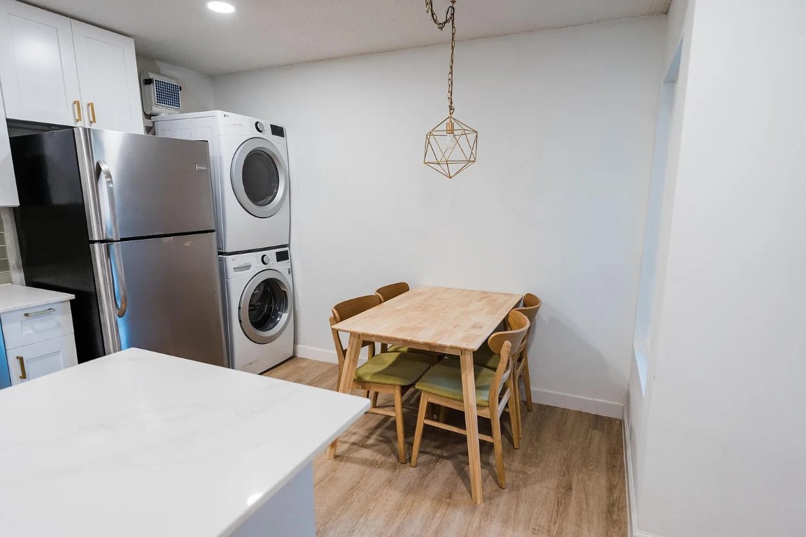 2600 Penny Lane, Unit 112 Austin, TX 78757 - Photo 6 of 20 a kitchen with a refrigerator a microwave and a table