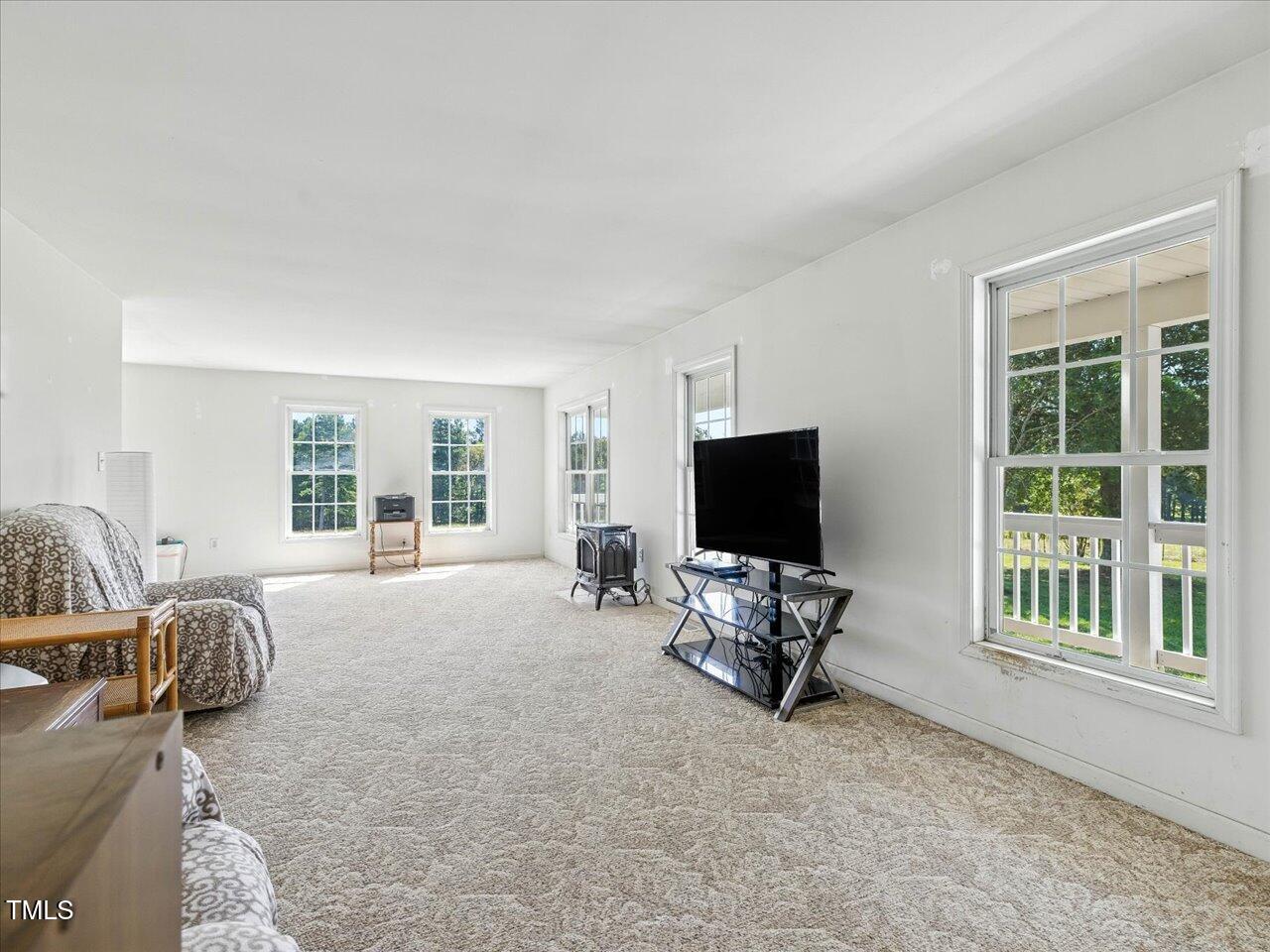 2892 Silk Hope Liberty Road Siler City, NC 27344 - Photo 10 of 74 a living room with furniture and a flat screen tv