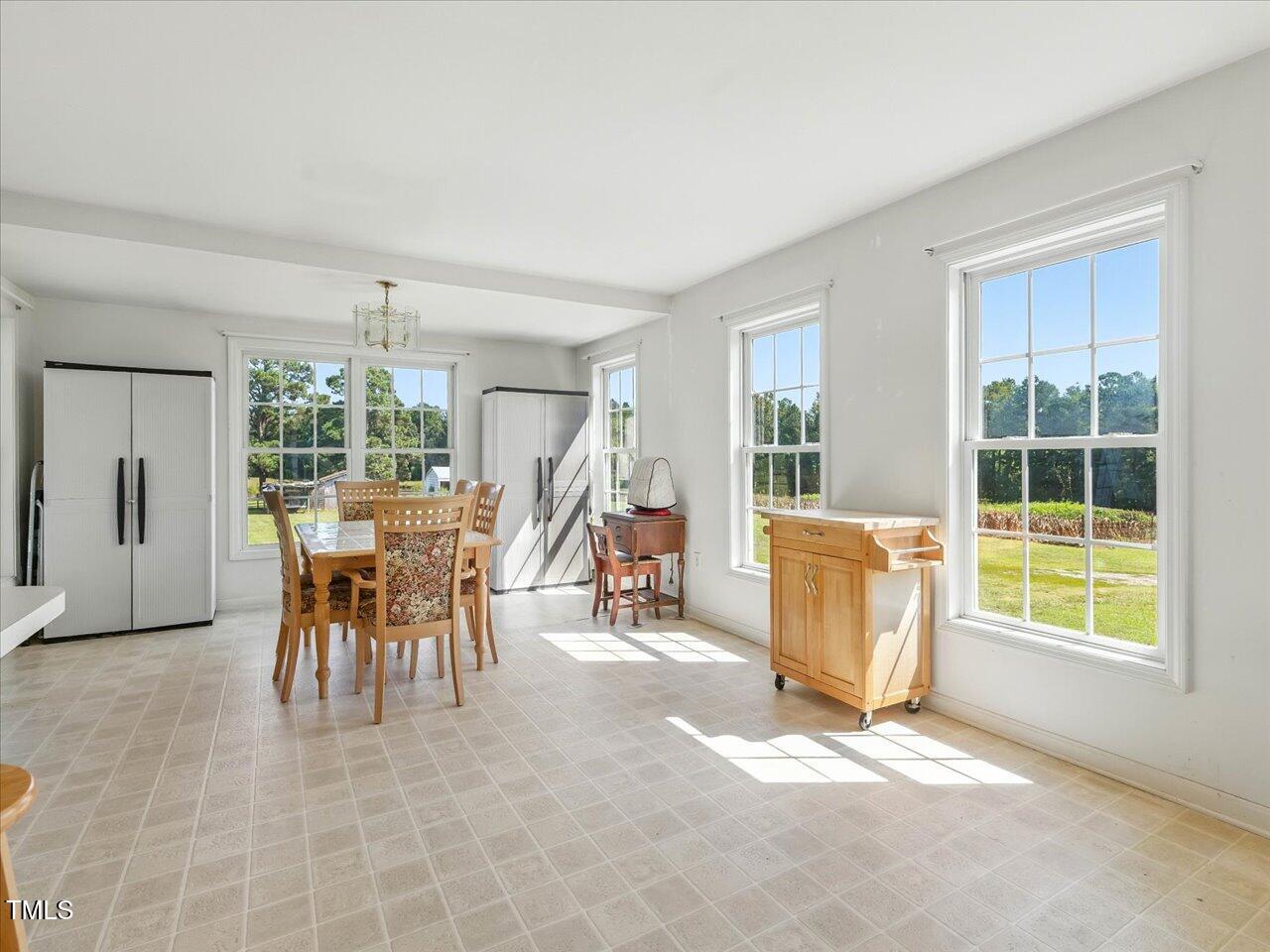 2892 Silk Hope Liberty Road Siler City, NC 27344 - Photo 11 of 74 a view of a dining room with furniture and a window
