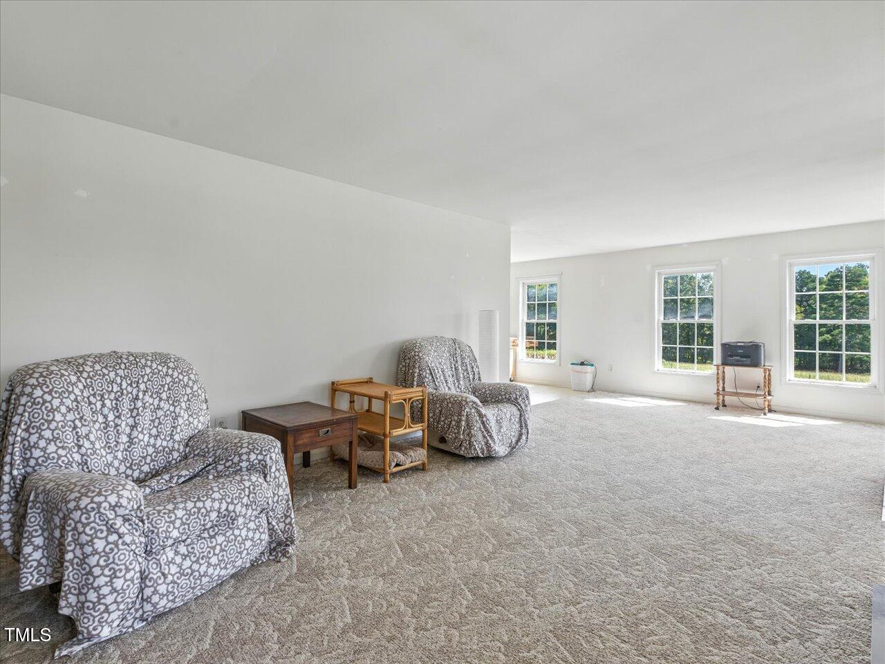 2892 Silk Hope Liberty Road Siler City, NC 27344 - Photo 12 of 74 a living room with furniture and a large window