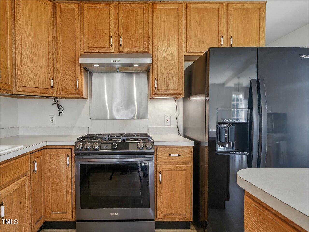 2892 Silk Hope Liberty Road Siler City, NC 27344 - Photo 19 of 74 a kitchen with stainless steel appliances granite countertop a stove a refrigerator and a microwave