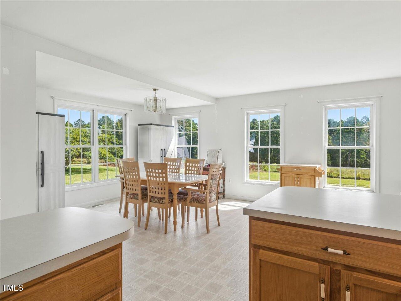 2892 Silk Hope Liberty Road Siler City, NC 27344 - Photo 20 of 74 a dining room with furniture and large windows