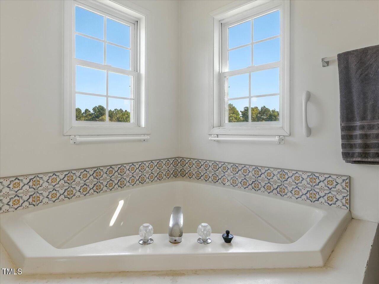 2892 Silk Hope Liberty Road Siler City, NC 27344 - Photo 25 of 74 a bath tub sitting in a bathroom next to a window