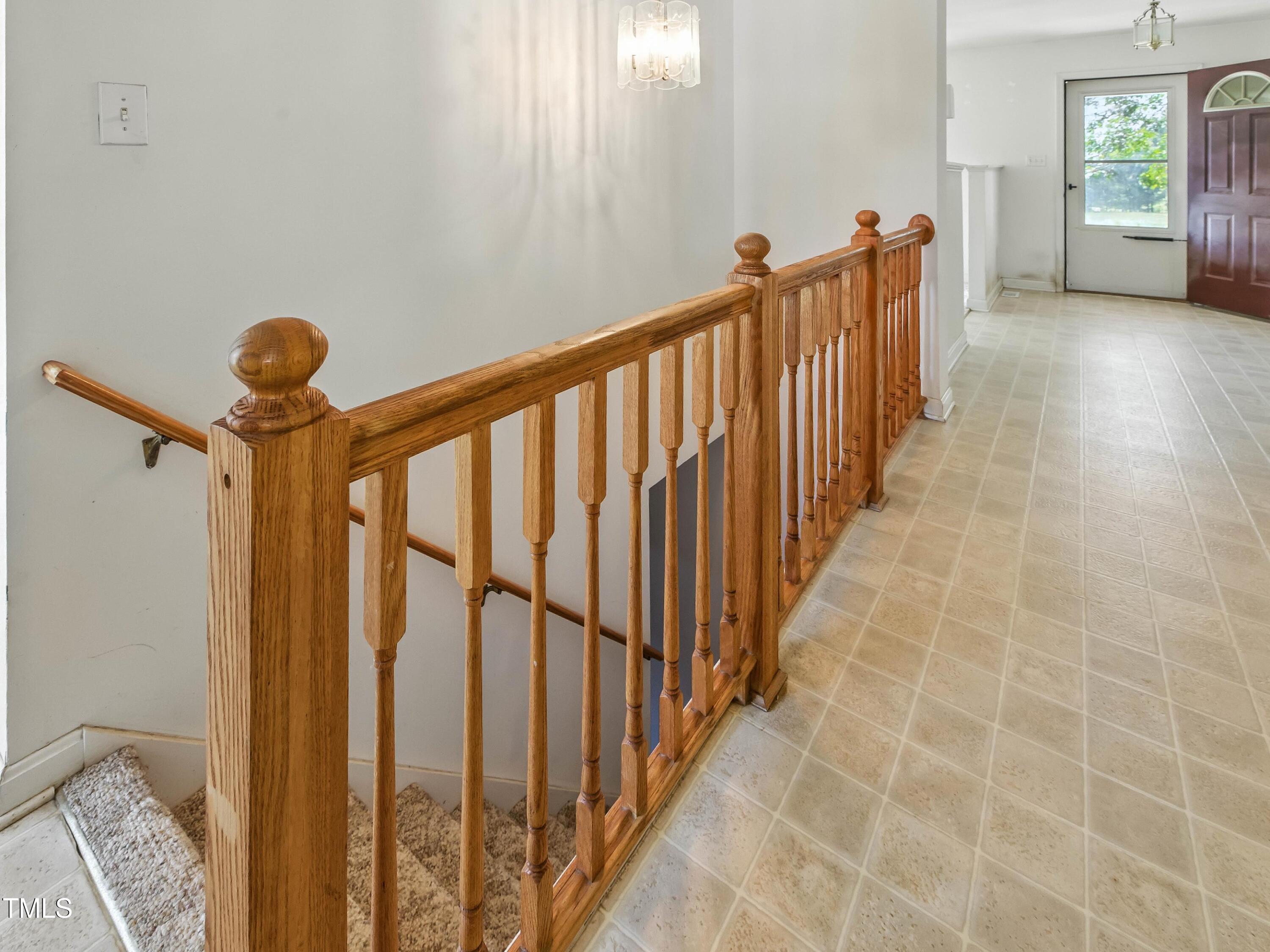 2892 Silk Hope Liberty Road Siler City, NC 27344 - Photo 31 of 74 a view of a hallway with wooden floor and stairs