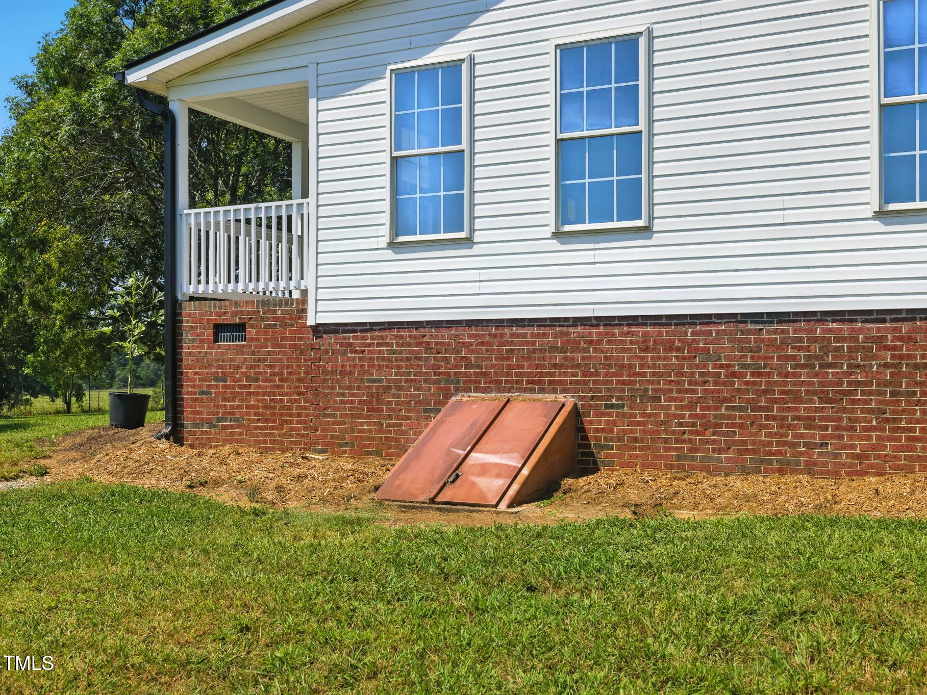 2892 Silk Hope Liberty Road Siler City, NC 27344 - Photo 36 of 74 a backyard of a house with wooden fence and a yard