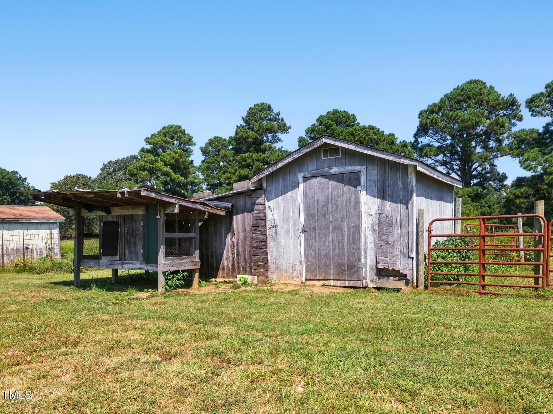 2892 Silk Hope Liberty Road Siler City, NC 27344 - Photo 62 of 74 a view of a backyard with table and chairs and potted plants