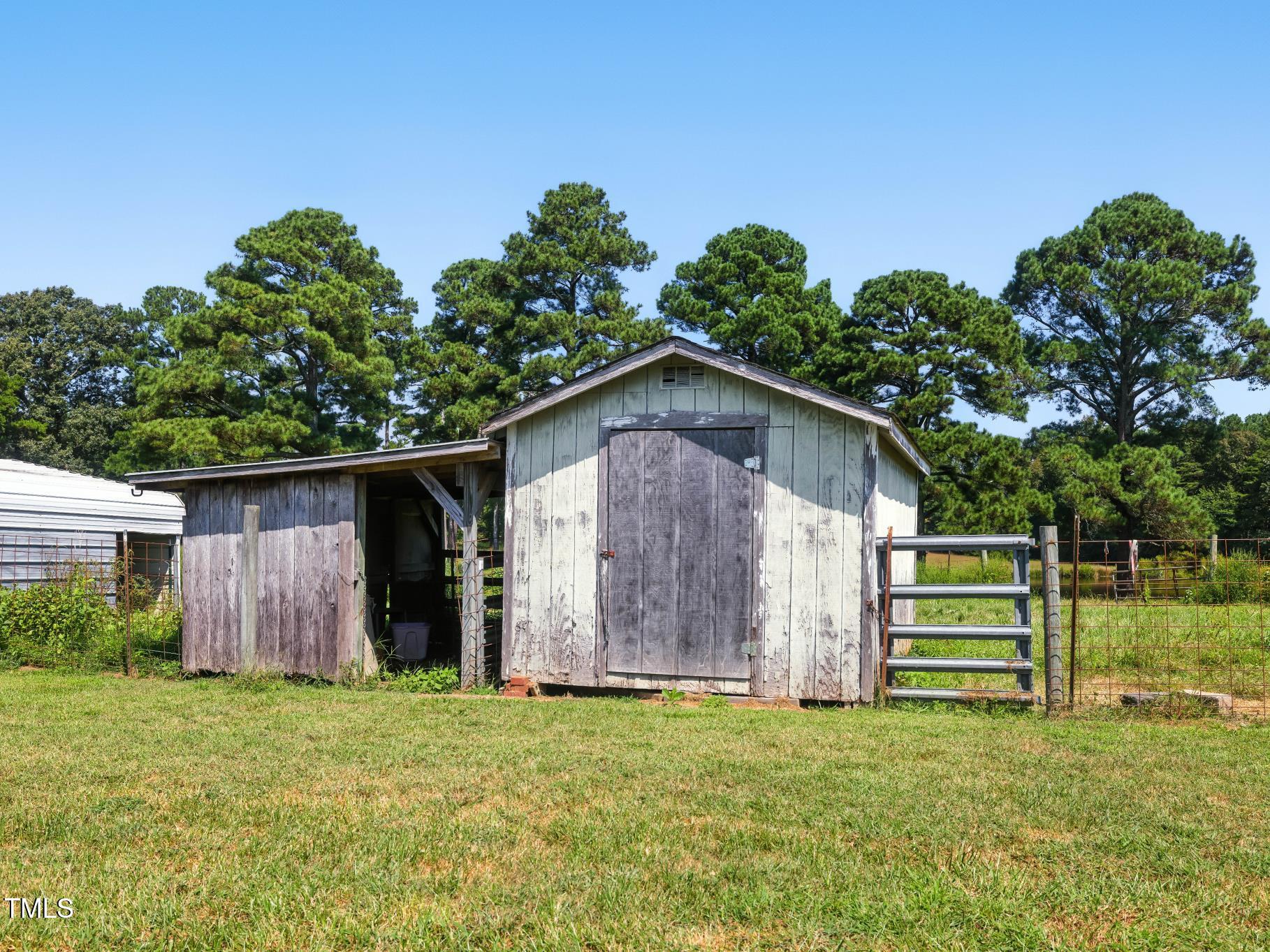 2892 Silk Hope Liberty Road Siler City, NC 27344 - Photo 63 of 74 a backyard of a house with plants and entertaining space
