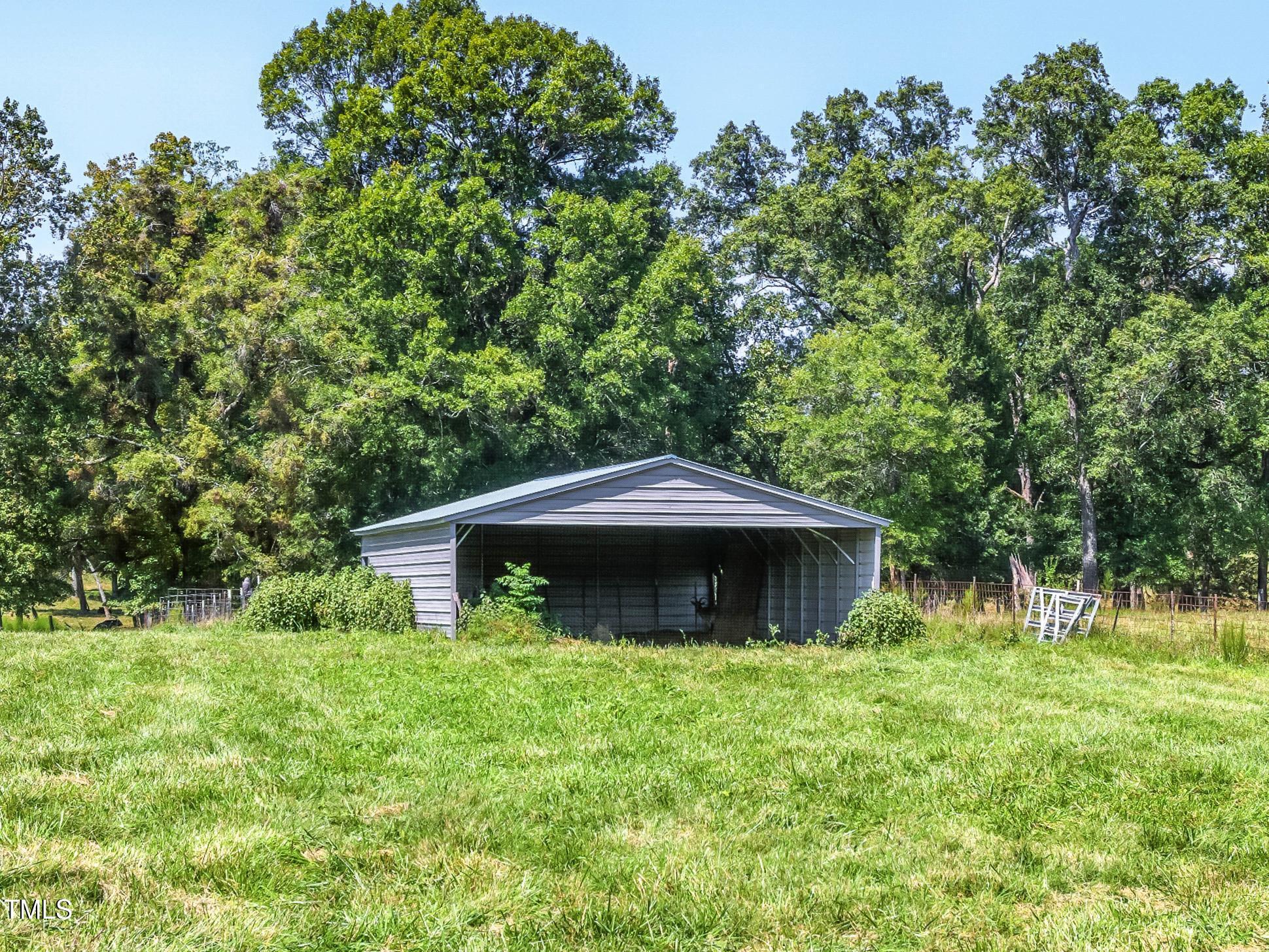 2892 Silk Hope Liberty Road Siler City, NC 27344 - Photo 65 of 74 a front view of a house with garden