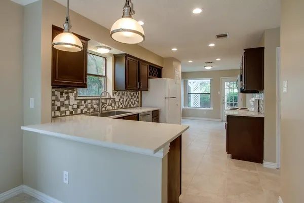 a kitchen with refrigerator and sink