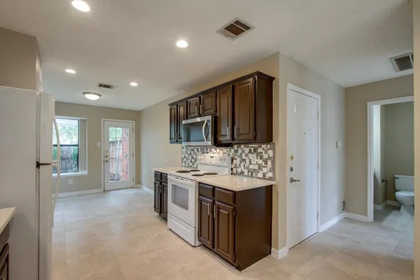 a kitchen that has a sink and a stove