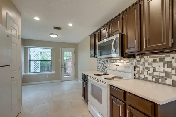 a kitchen that has a sink and a stove in it