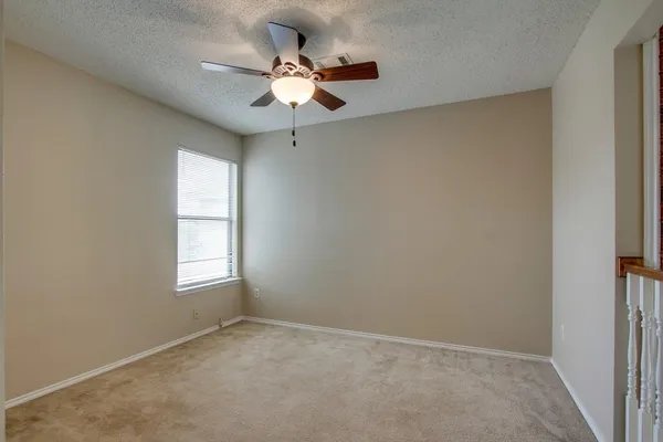 a view of a hallway with a chandelier fan