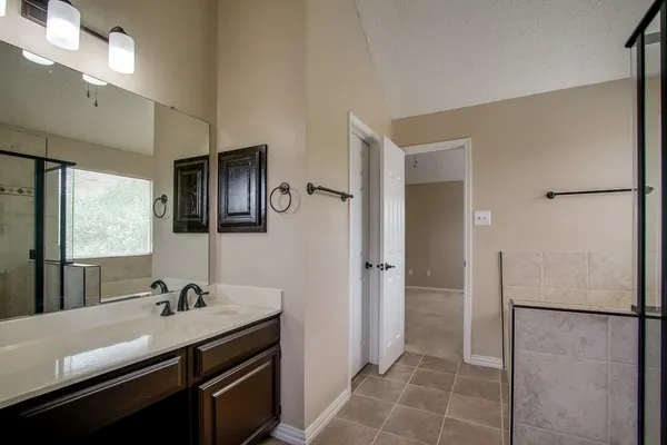 an empty room with a window and a ceiling fan