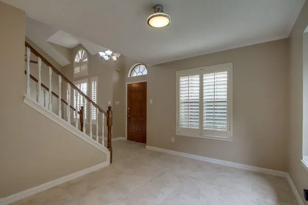 a large white kitchen with a large island oven a stove and a sink