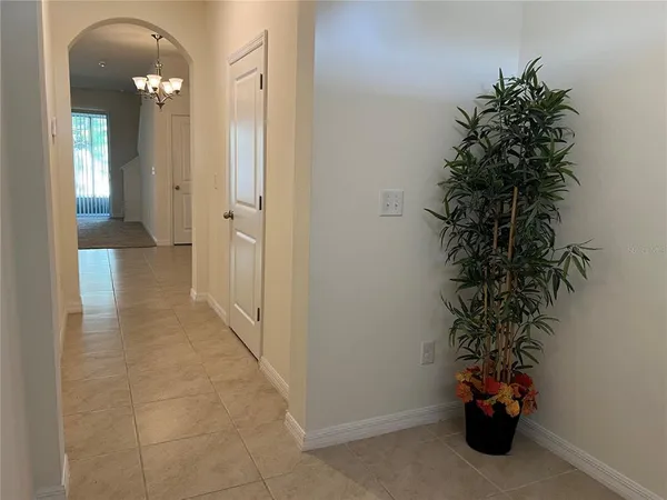 a view of a hallway with wooden shelves