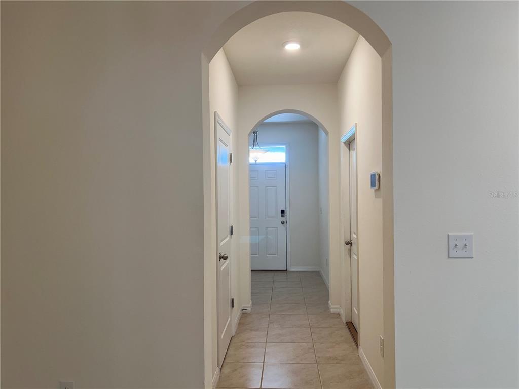 3816 Vignoble Lane Brandon, FL 33511 - Photo 5 of 21 a view of a hallway with wooden shelves