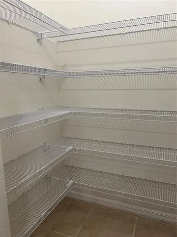 a kitchen with stainless steel appliances a sink a stove top oven a counter space and cabinets