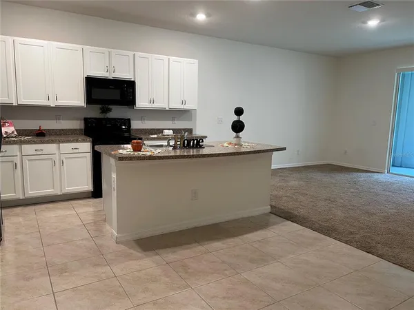 a kitchen with a sink a counter top space cabinets and stainless steel appliances