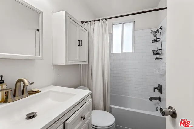 a bathroom with a sink a toilet and a bathtub