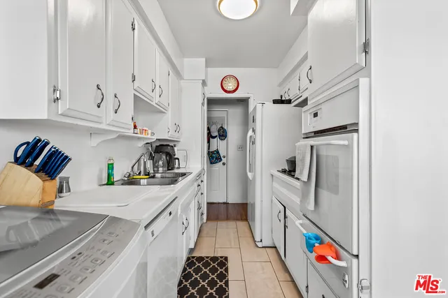 a kitchen with stainless steel appliances granite countertop a refrigerator and a stove