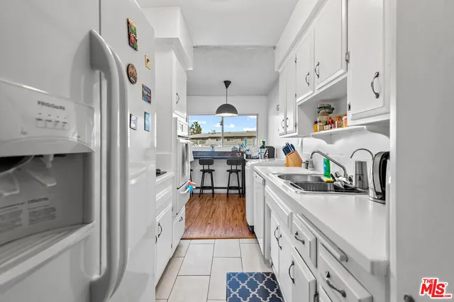 a kitchen with stainless steel appliances granite countertop a sink and cabinets