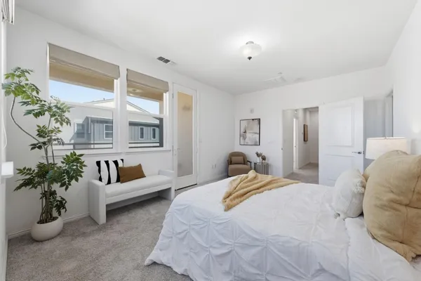 a bedroom with furniture and a potted plant