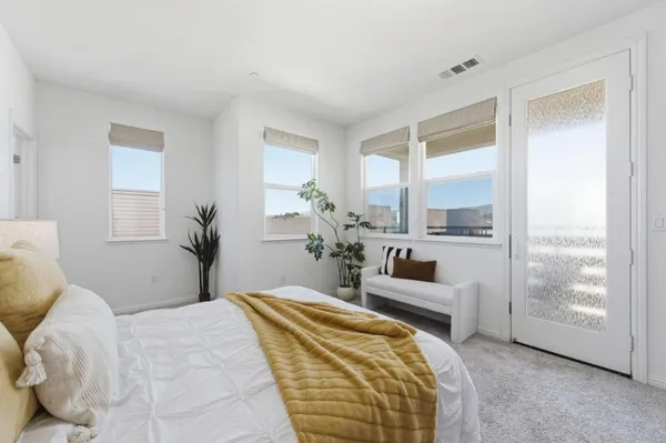 a bedroom with a balcony a bed and a couch