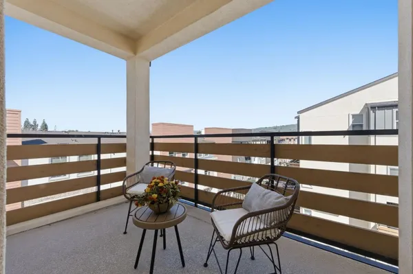a view of a chairs and table in the balcony