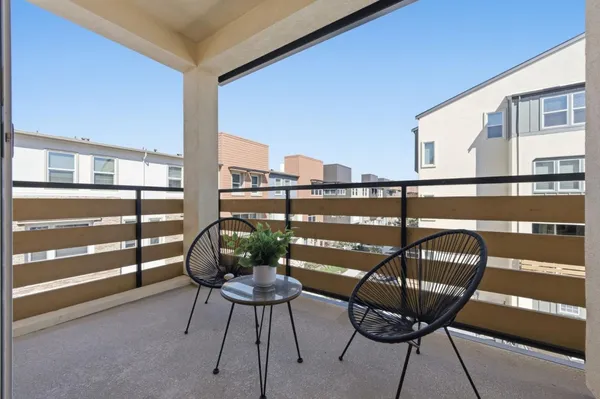 a view of a chairs and table in the balcony