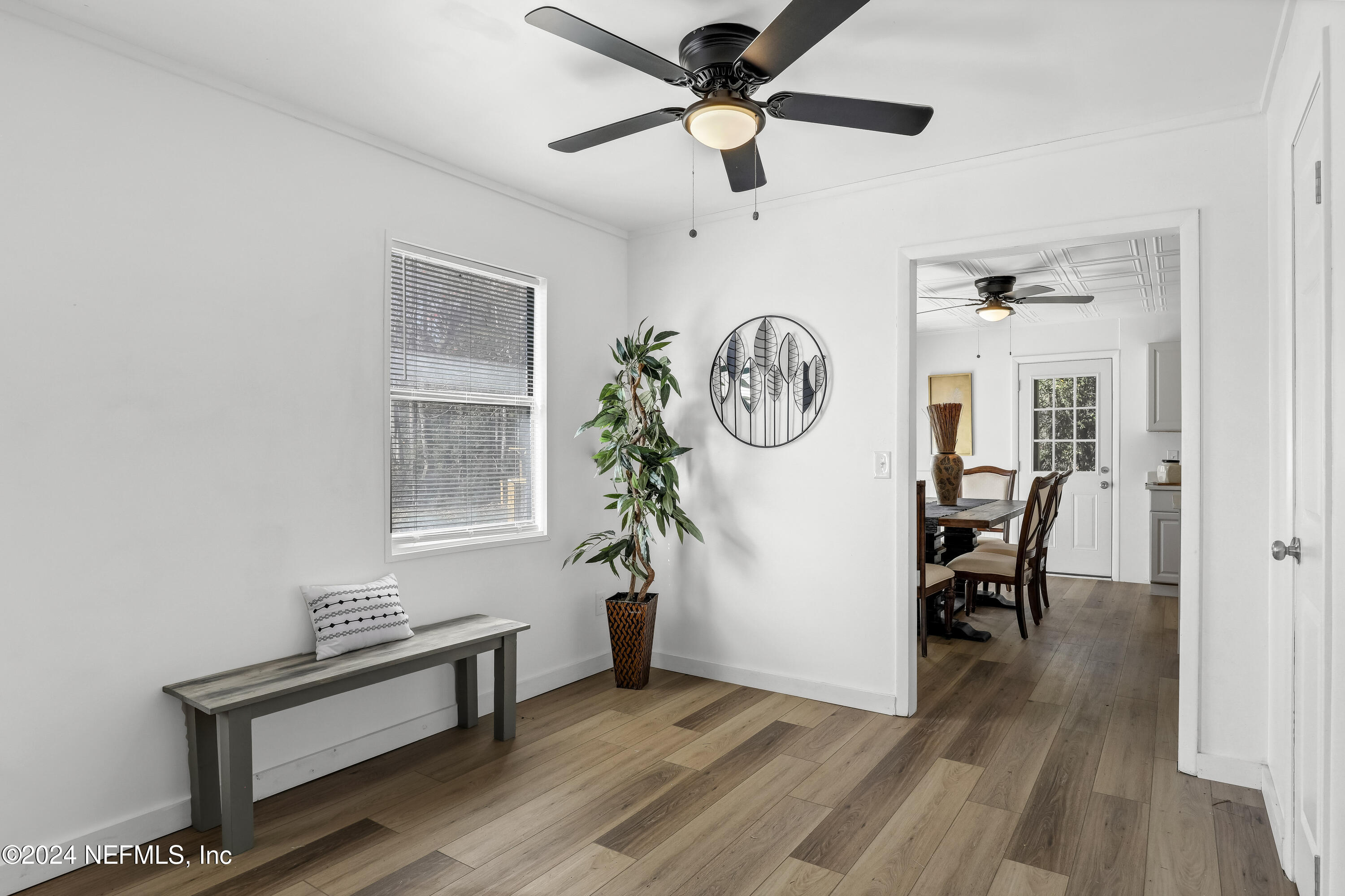 54221 Cravey Road Callahan, FL 32011 - Photo 19 of 52 a view of a hallway with wooden floor and a clock on a wall