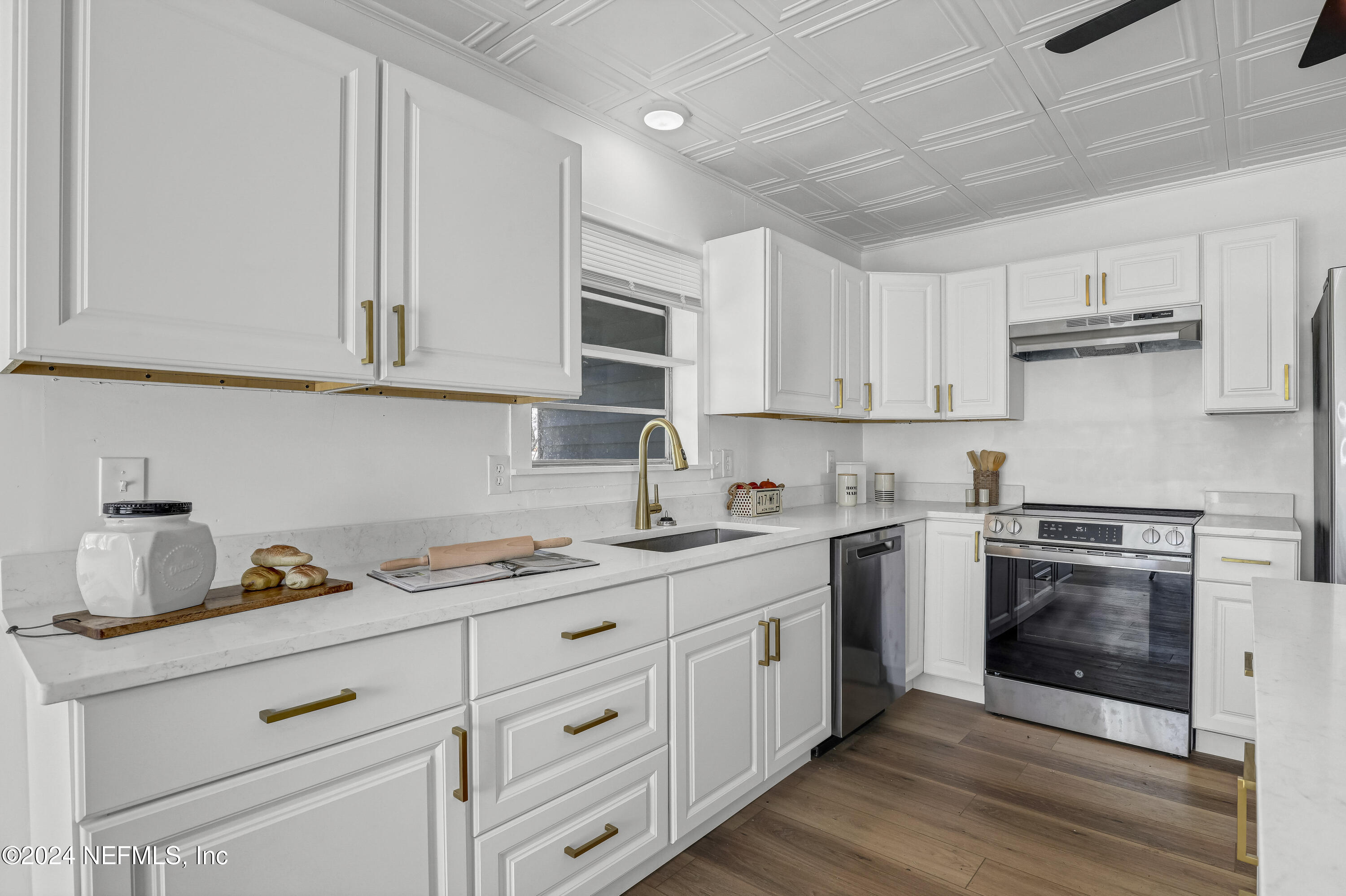 54221 Cravey Road Callahan, FL 32011 - Photo 27 of 52 a kitchen with cabinets stainless steel appliances a sink and wooden floor